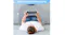 A person lying down using the lap desk pillow to support arms while holding a tablet A person lying down using the lap desk pillow to support arms while holding a tablet