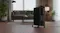 Black 11‑fin Goldair oil column heater placed on a wooden floor in a modern living room Black 11‑fin Goldair oil column heater placed on a wooden floor in a modern living room