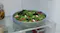 A view of a salad bowl stored inside the fridge A view of a salad bowl stored inside the fridge