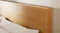 Detailed close-up of the Jasper bed headboard corner, highlighting the natural wood grain Detailed close-up of the Jasper bed headboard corner, highlighting the natural wood grain