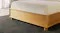 Low-angle view of the Jasper bed footboard and base Low-angle view of the Jasper bed footboard and base