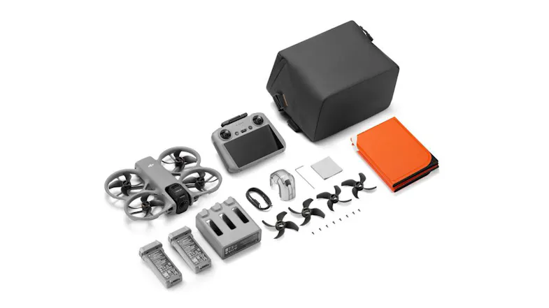 Flat lay of a DJI drone, screen remote, and orange accessories Flat lay of a DJI drone, screen remote, and orange accessories
