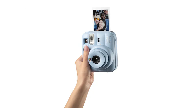 Hand holding an instant camera, ejecting a square photo Hand holding an instant camera, ejecting a square photo