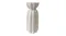 A tall white stoneware vase with a textured surface, fluted vertical ridges, and a cinched, hourglass-like shape A tall white stoneware vase with a textured surface, fluted vertical ridges, and a cinched, hourglass-like shape