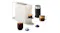Angled view of a white Espresso machine, black frother, mugs, and capsules Angled view of a white Espresso machine, black frother, mugs, and capsules