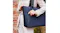A person wearing a beige blazer, carrying a navy tote bag A person wearing a beige blazer, carrying a navy tote bag