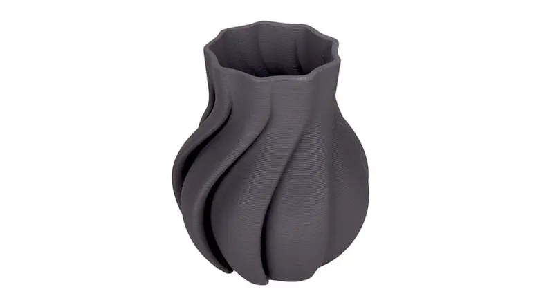 A small dark grey ceramic vase with a rounded body and twisted, spiralling ridges that curve upward to a softly scalloped rim A small dark grey ceramic vase with a rounded body and twisted, spiralling ridges that curve upward to a softly scalloped rim