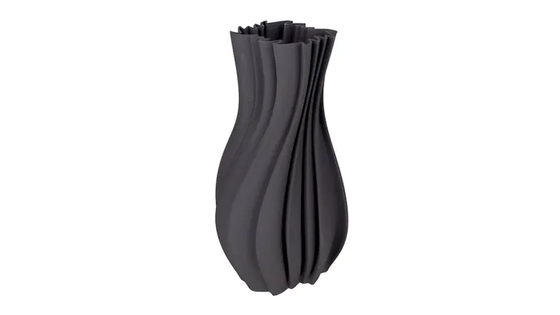 A tall, dark grey ceramic vase with a slim, curved body featuring deep vertical wave-like ridges A tall, dark grey ceramic vase with a slim, curved body featuring deep vertical wave-like ridges