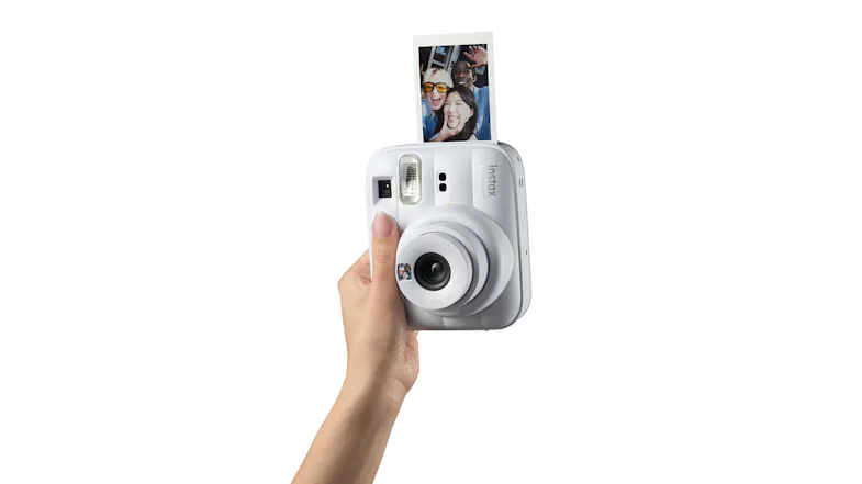 Hand holding an instant camera, ejecting a square photo Hand holding an instant camera, ejecting a square photo