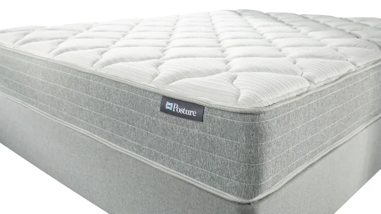 Close-up of Posture Queen Mattress showing quilted white top and gray textured side panels Close-up of Posture Queen Mattress showing quilted white top and gray textured side panels