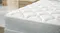 Detailed view of the plush, diamond-quilted white surface of a Sealy Posture Life Comfort mattress Detailed view of the plush, diamond-quilted white surface of a Sealy Posture Life Comfort mattress