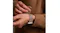 A view of a hand snapping on the watch via its magnetic clasp A view of a hand snapping on the watch via its magnetic clasp