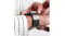 Close-up of a person adjusting the granite grey Link Bracelet Pro on their wrist Close-up of a person adjusting the granite grey Link Bracelet Pro on their wrist