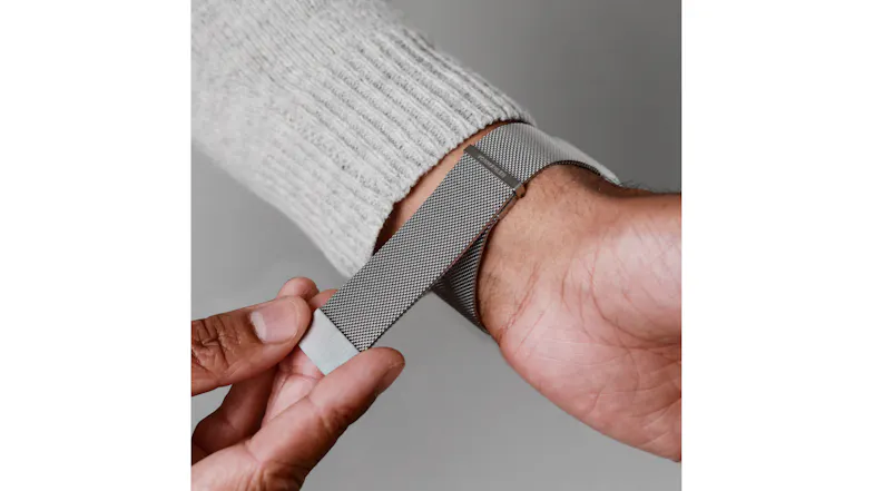 A view of a hand snapping on the watch via its magnetic clasp A view of a hand snapping on the watch via its magnetic clasp