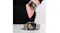A view of the watch displayed on a table while another is worn by a person at the back A view of the watch displayed on a table while another is worn by a person at the back