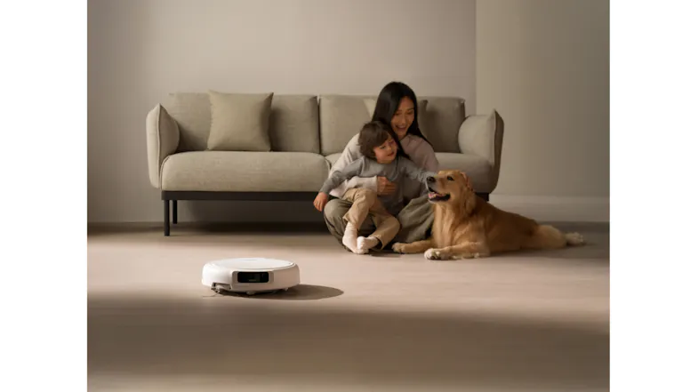 A low-angle shot shows the vacuum cleaner near a family on a sofa A low-angle shot shows the vacuum cleaner near a family on a sofa