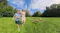 Candid shot of a woman, child, and dog running through a park Candid shot of a woman, child, and dog running through a park