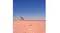 Photo capture of a child playing with a red shovel on a wide, sandy beach Photo capture of a child playing with a red shovel on a wide, sandy beach