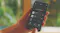 Hand holding a smartphone displaying a remote appliance control app Hand holding a smartphone displaying a remote appliance control app