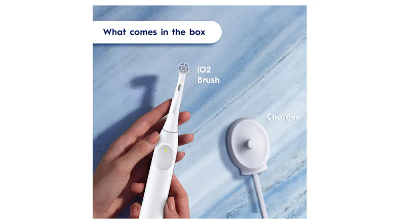 Top-down view of the toothbrush and charger on a blue surface Top-down view of the toothbrush and charger on a blue surface