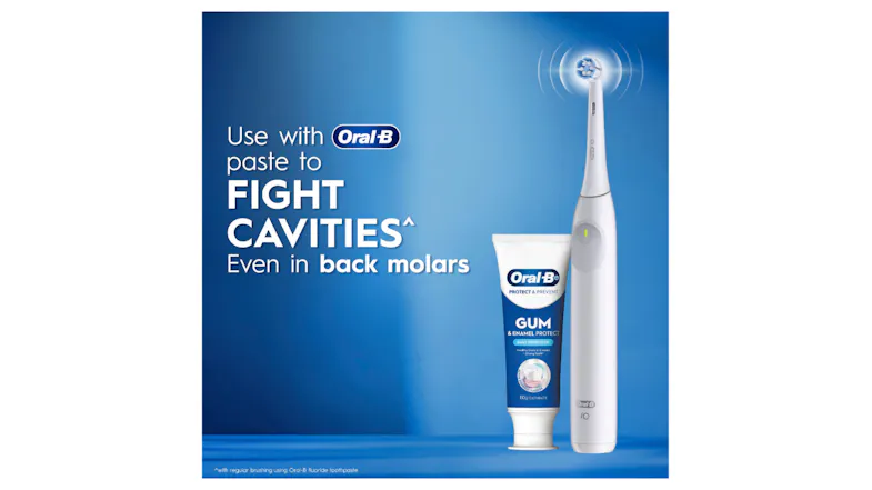 The white toothbrush standing next to a tube of gum protection paste The white toothbrush standing next to a tube of gum protection paste