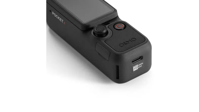 A tall black camera with a light and a tripod base A tall black camera with a light and a tripod base