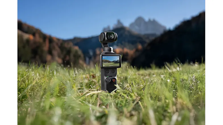 A DJI Osmo Pocket 4 action camera recording a mountainscape A DJI Osmo Pocket 4 action camera recording a mountainscape