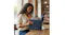 A woman walking in a park holding the laptop sleeve to her side A woman walking in a park holding the laptop sleeve to her side
