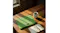 A textured laptop sleeve on a wooden table with coffee and a notebook A textured laptop sleeve on a wooden table with coffee and a notebook