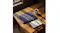 A textured laptop sleeve on a wooden table with coffee and a notebook A textured laptop sleeve on a wooden table with coffee and a notebook