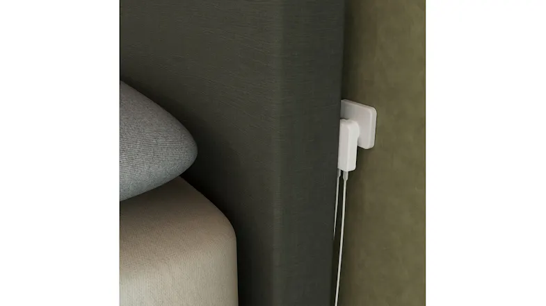 Close-up of a slim white charger fitted in a narrow wall gap Close-up of a slim white charger fitted in a narrow wall gap