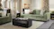 Closer view of the Botany three‑seater sofa in green fabric, centred behind a black coffee table Closer view of the Botany three‑seater sofa in green fabric, centred behind a black coffee table