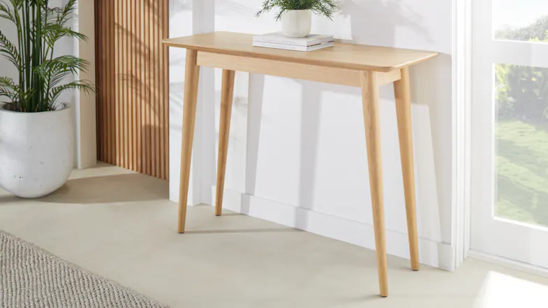 Helsinki 1060mm hall table in light oak positioned against a wall in a bright entryway Helsinki 1060mm hall table in light oak positioned against a wall in a bright entryway