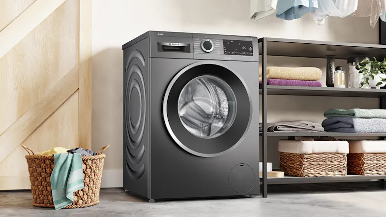 Bosch front loader washing machine in a bright laundry room Bosch front loader washing machine in a bright laundry room