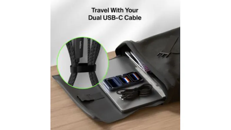 Coiled black cable with a strap inside a travel bag Coiled black cable with a strap inside a travel bag