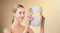 Person holding the LED face mask near the face, angled to show the exterior design Person holding the LED face mask near the face, angled to show the exterior design