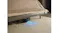 Lifestyle image of the robotic vacuum cleaning beneath a bed on carpet Lifestyle image of the robotic vacuum cleaning beneath a bed on carpet