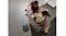 Overhead view of the robotic vacuum cleaning a kitchen floor beside a kitchen island Overhead view of the robotic vacuum cleaning a kitchen floor beside a kitchen island