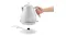 A hand lifts the De'Longhi kettle off its circular power base, demonstrating cordless use A hand lifts the De'Longhi kettle off its circular power base, demonstrating cordless use