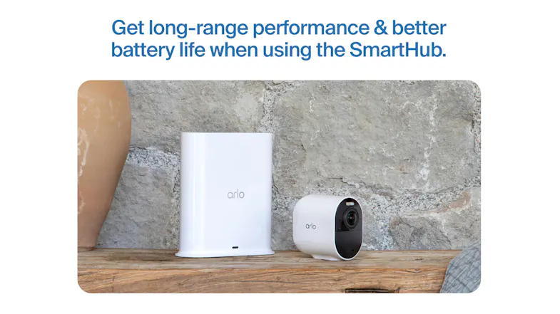 A tall white hub and a compact camera sitting on a wooden shelf A tall white hub and a compact camera sitting on a wooden shelf