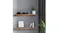 Two solid wood floating shelves on a grey wall, styled with camera lenses, books, framed art, and potted plants Two solid wood floating shelves on a grey wall, styled with camera lenses, books, framed art, and potted plants