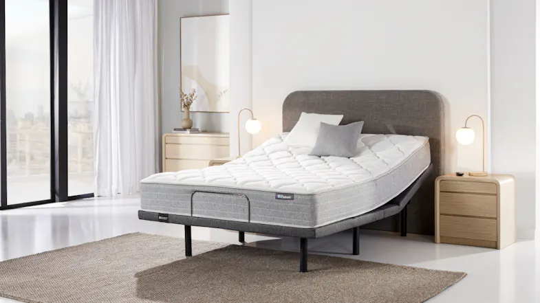 Angled bedroom view of a Sealy Posture Life Comfort queen mattress on an Element adjustable base Angled bedroom view of a Sealy Posture Life Comfort queen mattress on an Element adjustable base