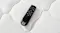 Top‑down close‑up of a black Sealy remote control placed on the mattress surface Top‑down close‑up of a black Sealy remote control placed on the mattress surface