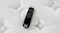 Top‑down close‑up of a black Sealy remote control resting on the white quilted mattress surface Top‑down close‑up of a black Sealy remote control resting on the white quilted mattress surface
