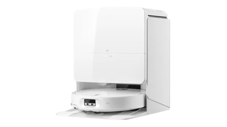 Left-facing view of the white Roborock multifunctional docking station with the circular robotic vacuum docked inside Left-facing view of the white Roborock multifunctional docking station with the circular robotic vacuum docked inside