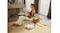 Lifestyle scene showing the Roborock robotic vacuum cleaning a carpeted living area Lifestyle scene showing the Roborock robotic vacuum cleaning a carpeted living area