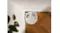 Overhead view of the robotic vacuum positioned tightly against a wall corner Overhead view of the robotic vacuum positioned tightly against a wall corner