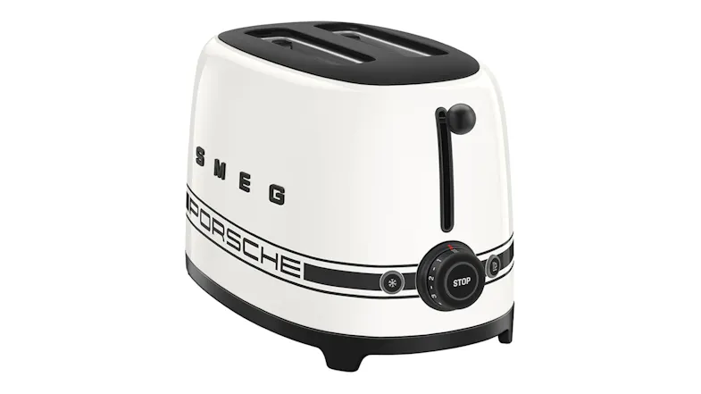 Right-side profile of the Smeg Porsche toaster featuring the black lever and "PORSCHE" decal Right-side profile of the Smeg Porsche toaster featuring the black lever and "PORSCHE" decal