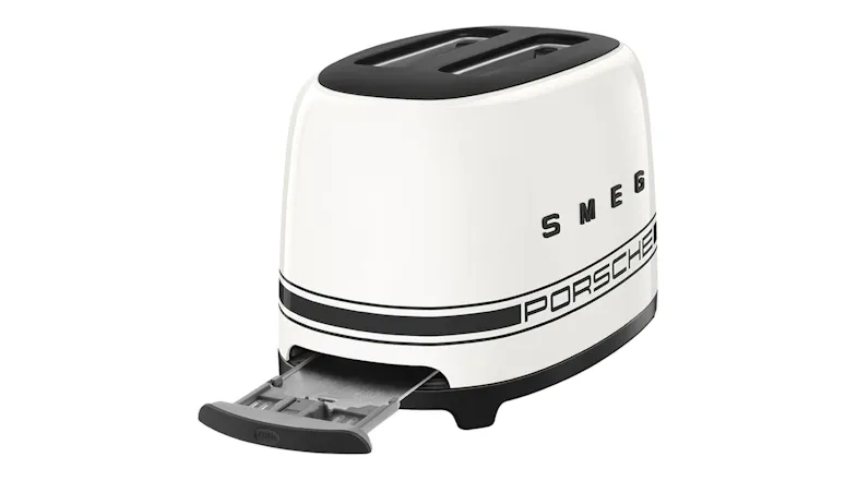 Rear view of the white Smeg Porsche toaster with the stainless steel crumb tray extended Rear view of the white Smeg Porsche toaster with the stainless steel crumb tray extended