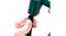 Hands attaching a vertical pole to the plastic joint of a green shelving rack Hands attaching a vertical pole to the plastic joint of a green shelving rack